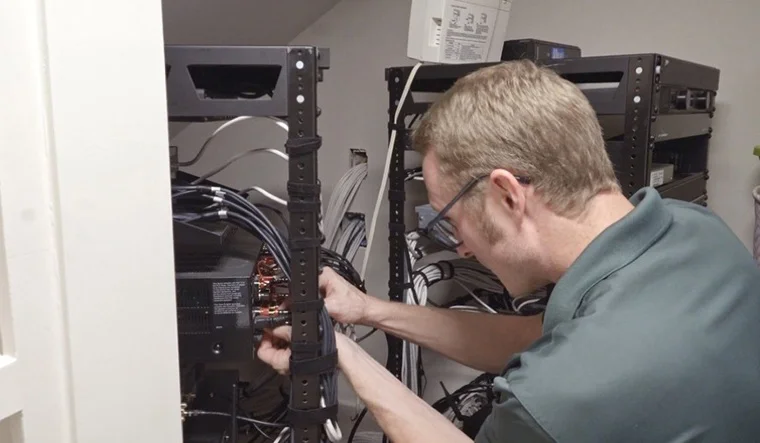 Technician terminating low-voltage cabling in a structured wiring rack