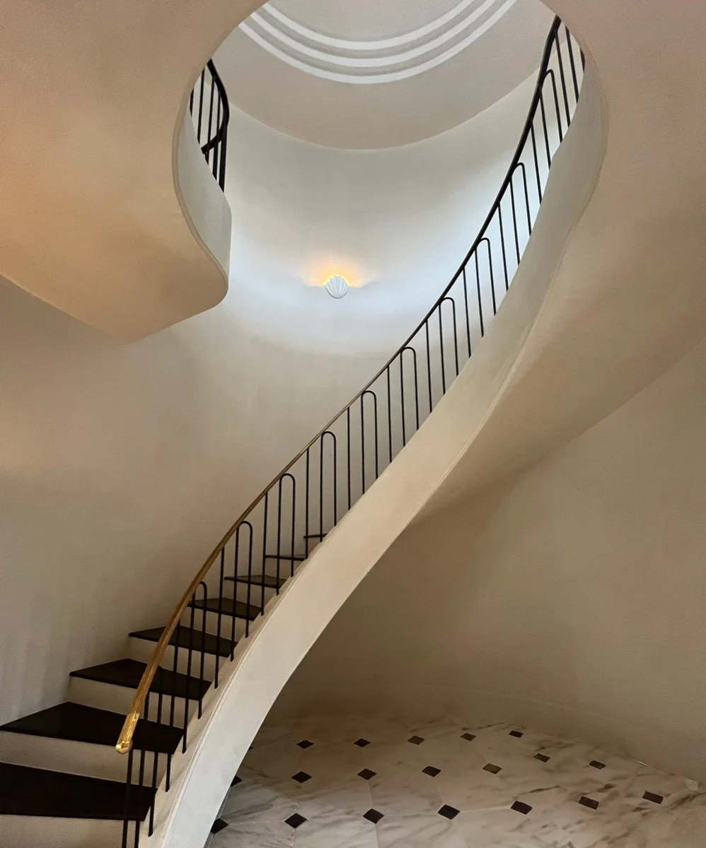 Curved staircase with architectural accent lighting in a luxury Austin, TX home