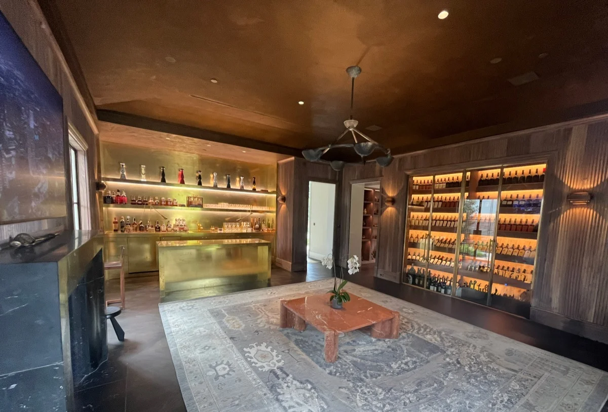 Home bar and wine room with backlit display lighting in a luxury Austin, TX residence