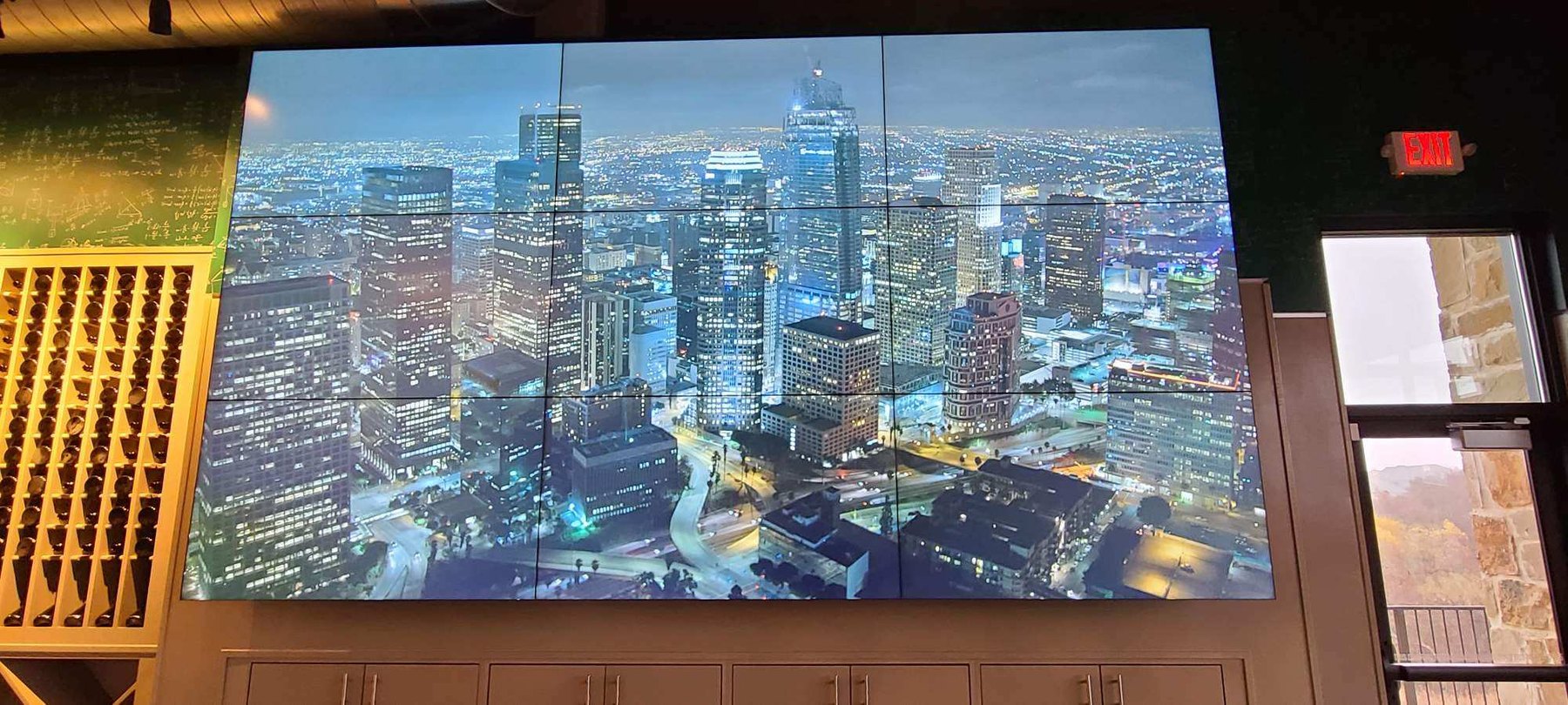 Tiled LCD video wall displaying a city skyline, installed by AV Connect in an Austin, TX restaurant