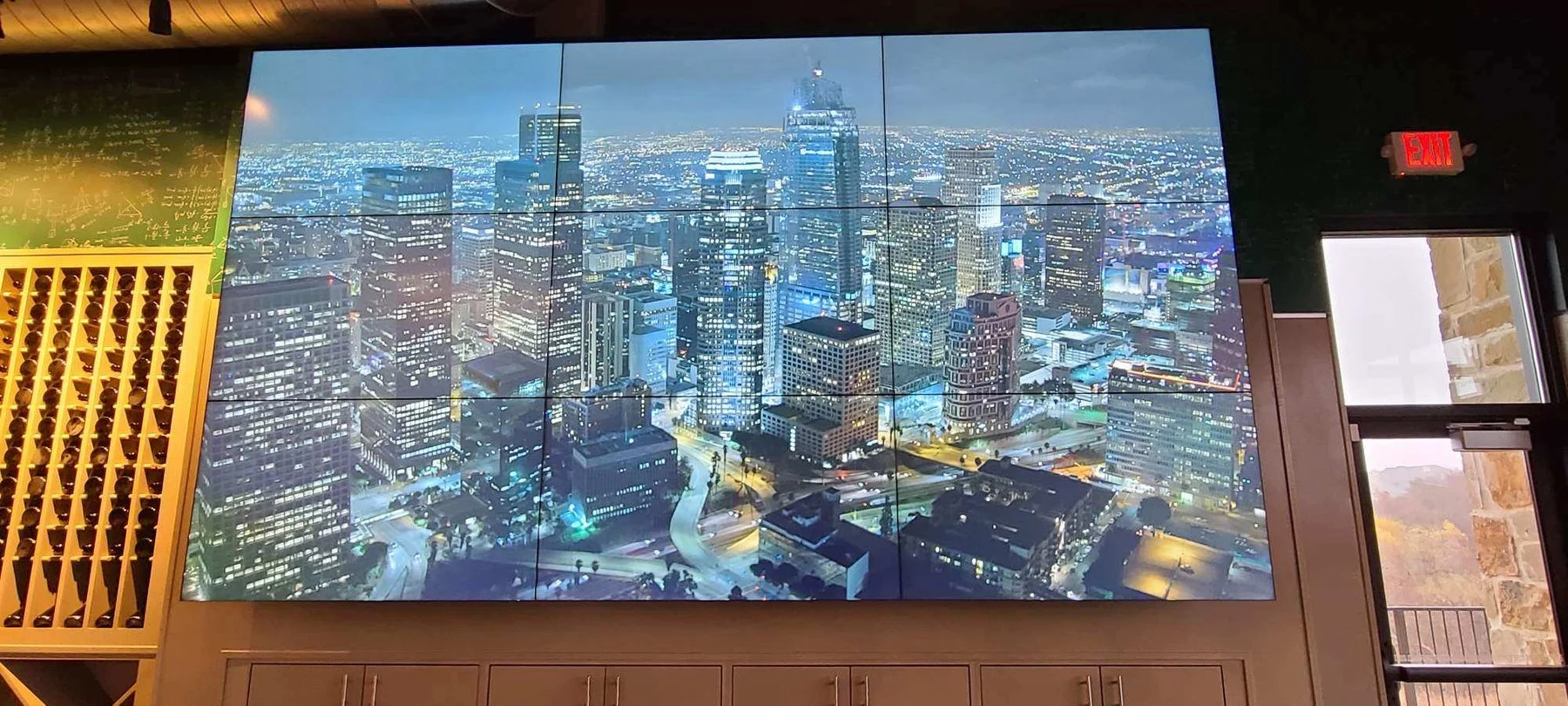 Tiled LCD video wall displaying a city skyline, installed by AV Connect in an Austin, TX restaurant