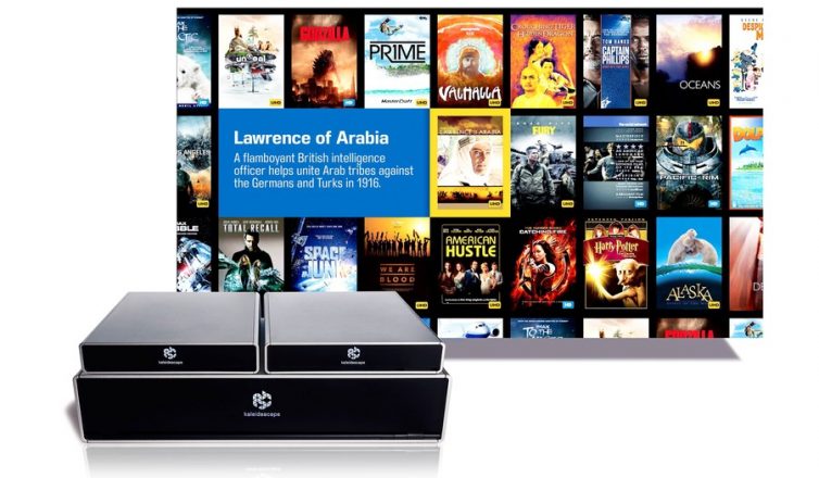 image of kaleidescape strato movie player and terra movie server with a background displaying a grid of movie covers, including 'lawrence of arabia' highlighted in the center.