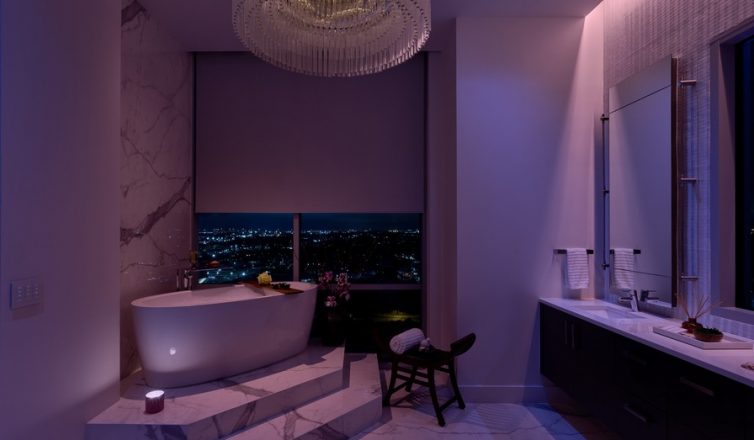 a modern bathroom illuminated by purple and white lighting in a lutron system.